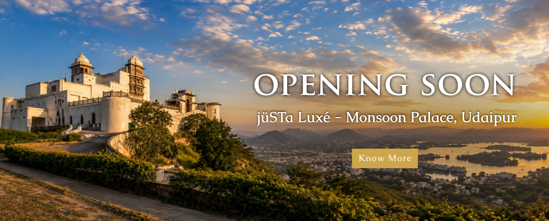 Opening Soon: juSTA Luxé – Monsoon Palace, Udaipur, shown at sunset with a city below and a gold 'Know More' button.