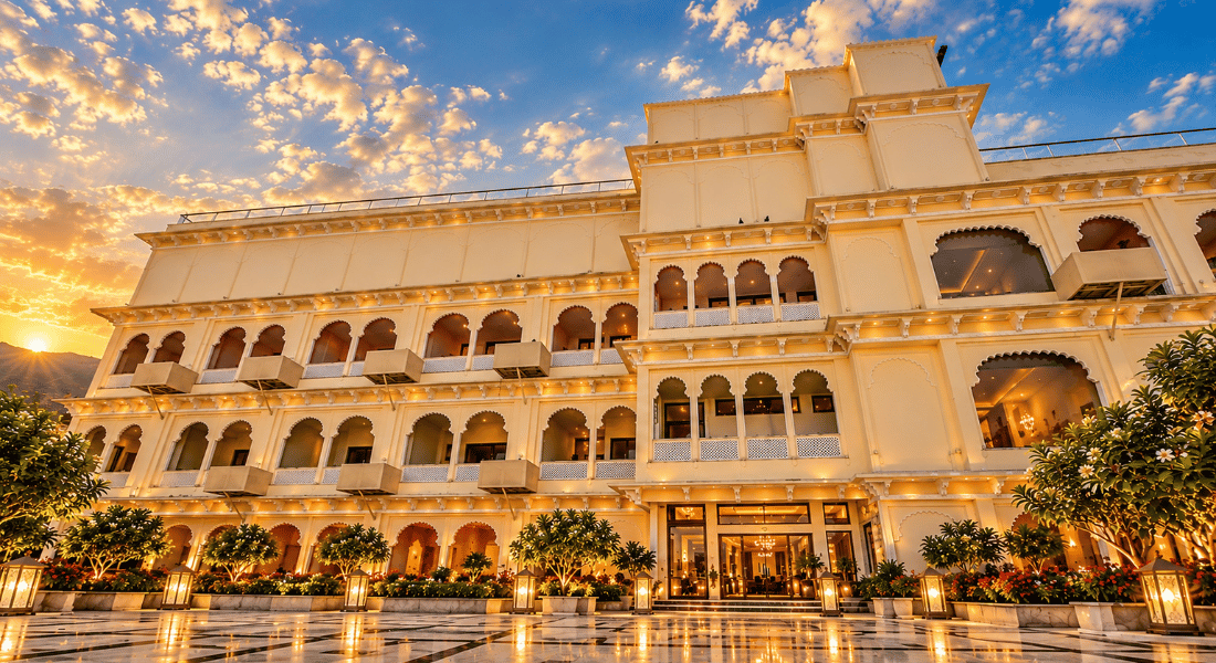 Monsoon Sunlit luxury hotel with arched balconies and a glowing courtyard at sunset.