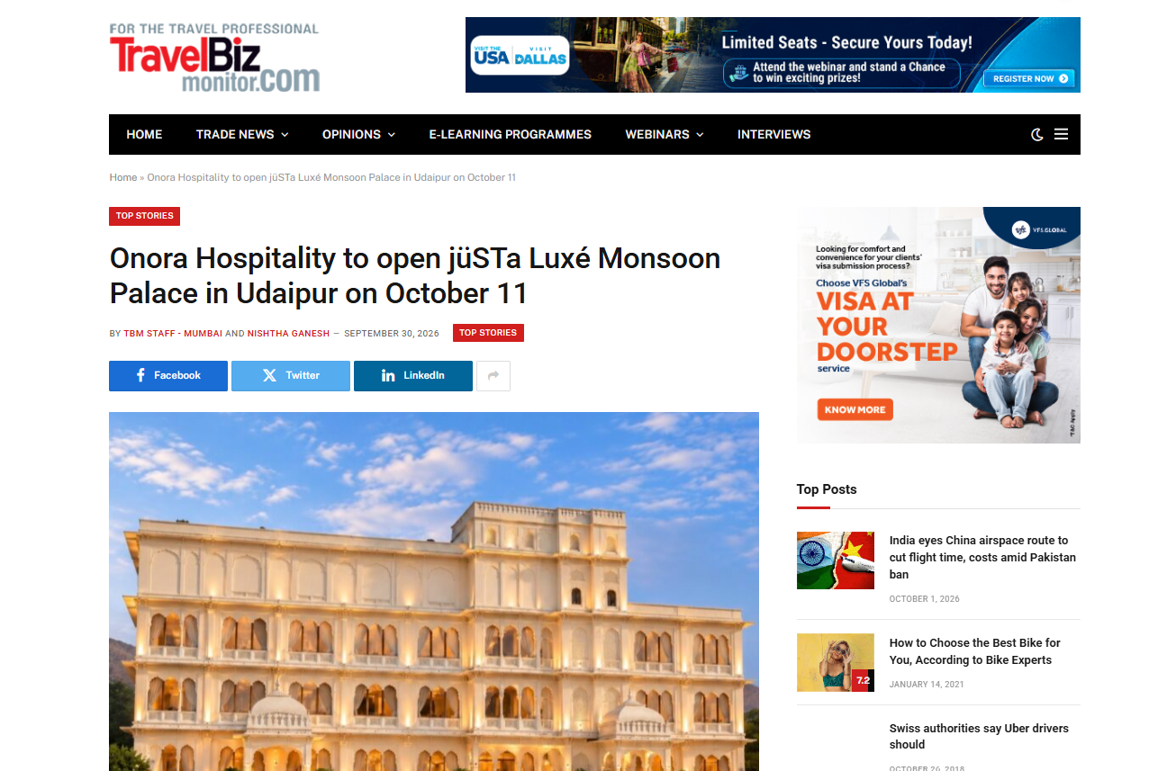 TravelBizMonitor Featured Onora Hospitality to Open jüSTa Luxé Monsoon Palace in Udaipur Exterior view of a grand sandstone palace with multiple levels of arched windows and balconies, bathed in warm light.